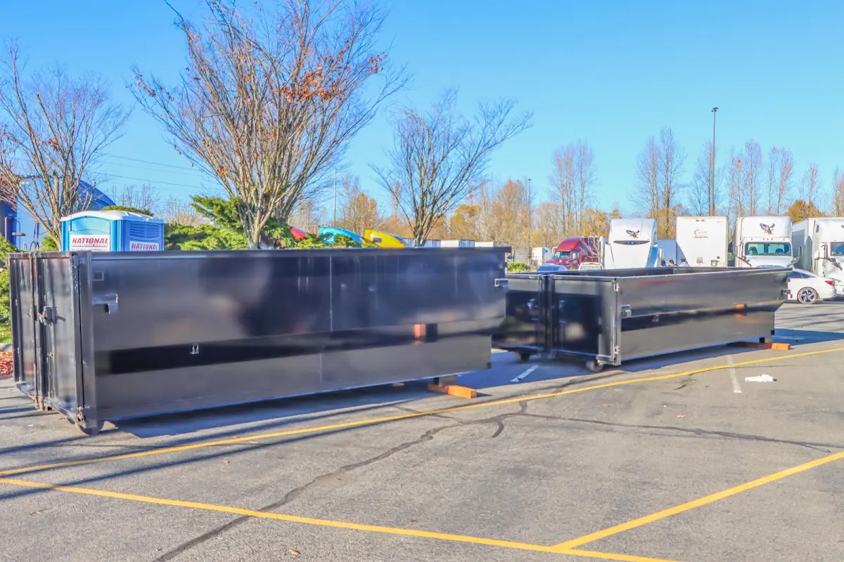 Professional dumpster rental service with roll-off container on residential driveway in Riverton